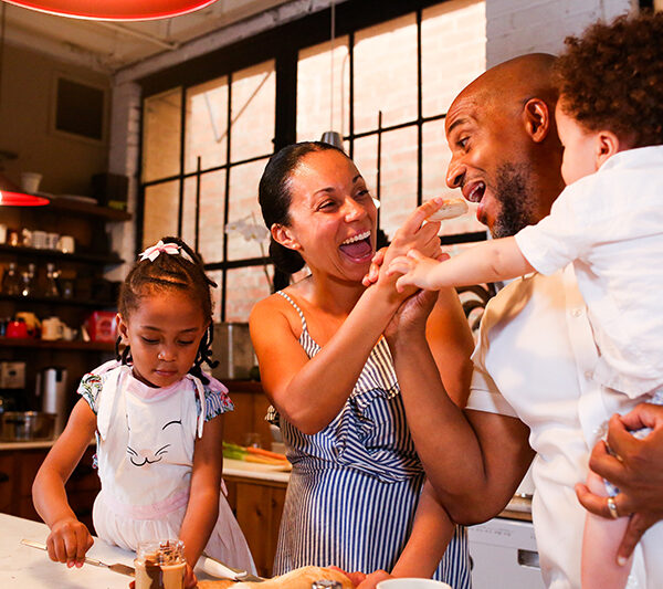 Happy Family using their Kitchen. Cooking and eating.