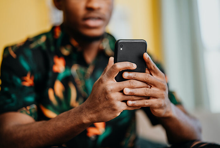 Man looking at donation pages on smart phone.