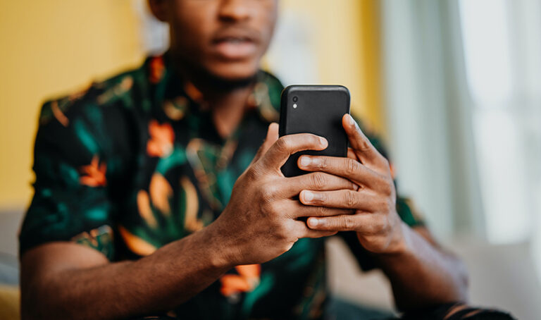 Man looking at donation pages on smart phone.